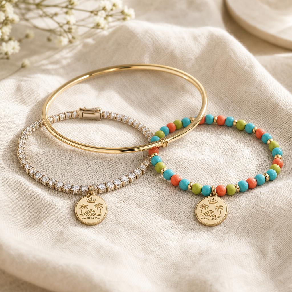 Yaadie Royale diamond tennis bracelet, gold bangle and beaded bracelet with crest charms
